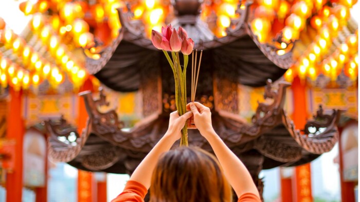 A Woman at a Temple in Malaysia offering a sacrifice 